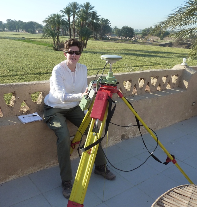 Image of the author sitting on a balcony overlooking an Egyptian field with a differential GPS.